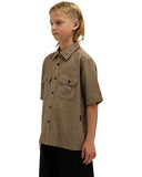 Volcom Revel Youth SS Boys Shirt in Earth brown side profile view showing the comfortable casual youth short sleeve length and clean stitched lower hemline structure, sold by Point Break Cambridge local family surf shop at 63 Duke street.