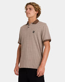 Volcom Stonelord Polo Shirt in Brown Stone side profile view showing the comfortable casual short sleeve length and clean stitched split hemline, sold by Point Break Cambridge local family surf shop at 63 Duke street.