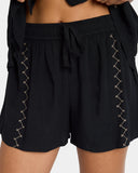 Volcom Womens Bloomz Short in Black close up view highlighting the premium textured fabric weave, elastic gathering details, and subtle embroidered stone logo, sold by Point Break Cambridge local family surf shop at 63 Duke street.