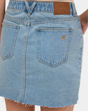 Volcom Womens Ramped Mini Denim Skirt in Stone Blue close up view highlighting the stone washed heavyweight cotton denim fabric texture metallic zipper fly and hardware detailing, sold by Point Break Cambridge local family surf shop at 63 Duke street.