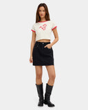 Volcom Womens Stoneray Skirt in Black front view showcasing the flattering fitted mini skirt silhouette classic zip fly and metal button closure practical scoop front pockets with metal eyelet details and timeless black cotton construction, sold by Point Break Cambridge local family surf shop at 63 Duke Street.