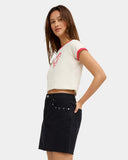 Volcom Womens Stoneray Skirt in Black side profile view showcasing the flattering fitted mini length structured cotton fabric classic five-pocket-inspired design and versatile black surf streetwear styling, sold by Point Break Cambridge local family surf shop at 63 Duke Street.