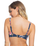 A rear view of a woman wearing a navy bikini top with a multicolor floral pattern, featuring adjustable straps and a underwired D-cup shape. Roxy Sunset Boogie D-Cup Underwired Bikini Top - Mood Indigo