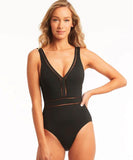 Close up shot of model wearing Sea Level Eco Essentials Spliced Waisted One Piece Swimsuit - Black on a white background.