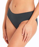 A model wearing a mid-cut charcoal swim pant, focusing on the fabric texture and fit. Sea Level Lola Shimmer Mid Pant - Charcoal | Point Break