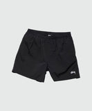 A pair of black Stussy Water Big Beachshorts with an elastic waistband, grown-on waistband, and internal drawcord. It features front in-seam pockets and a small embroidered logo on the left leg.