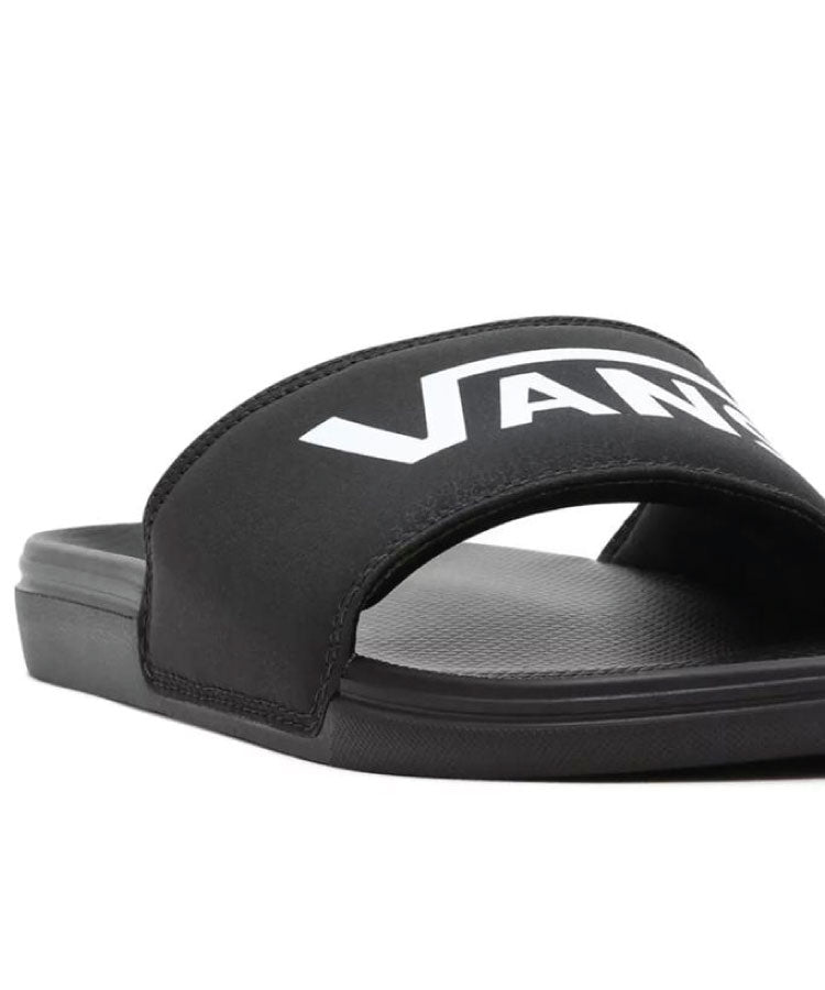 A pair of Vans La Costa Slides in black color with the Vans logo on the strap. Vans La Costa Slides - Black / Black