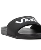A pair of Vans La Costa Slides in black color with the Vans logo on the strap. Vans La Costa Slides - Black / Black
