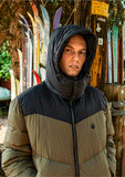 Front view of a man wearing the Volcom Goldsmooth jacket in Military green showing the full zip closure and zippered chest pocket.