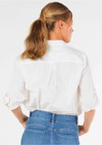 Back view of the women's Betty Basics Heston Shirt showcasing the relaxed fit and curved high-low hem.
