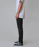 Side full-length view of the men's Dickies 818 slim twill skate pants in classic solid black.