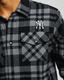 Close-up detail of the split check plaid pattern and high-density New York Yankees embroidered chest logo.