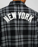 Back view of the men's Majestic Yankees plaid shacket displaying the New York lettering.