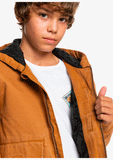 Close-up detail of the warm fleece interior lining and durable water-repellent shell on the youth Quiksilver jacket.