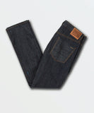 Close up detail of the premium unwashed rinse denim grain, dark metal pocket rivets, and Volcom branded hardware.