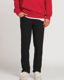 Front full-length view of man wearing the men's Volcom Vorta slim fit jeans in solid Black Out denim.